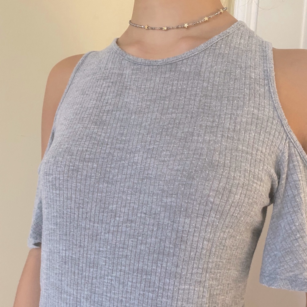 A shoulderless grey blouse